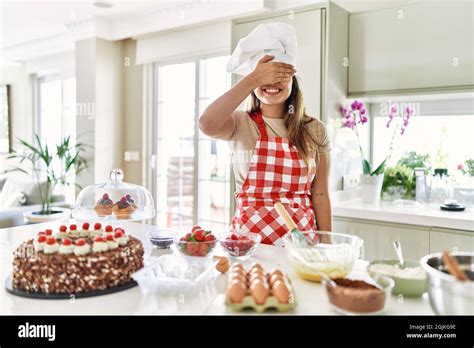 Beautiful Young Brunette Pastry Chef Woman Cooking Pastries At The Kitchen Smiling And Laughing