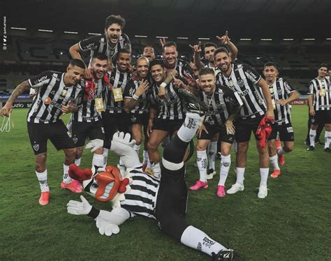 A Group Of Men Standing On Top Of A Soccer Field