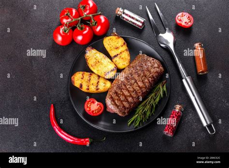 Ribeye Steak With Potatoes Onions And Cherry Tomatoes Juicy Steak