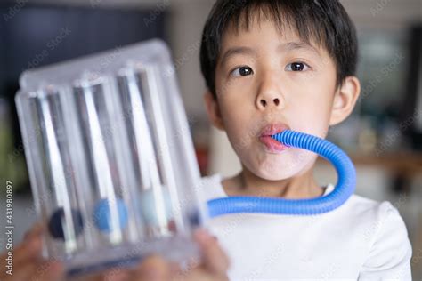 Thin Boy Uses A Tri Ball Incentive Spirometer For Check His Lung