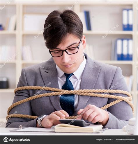 Businessman Tied Up With Rope In Office Stock Photo By ©elnur 378068962