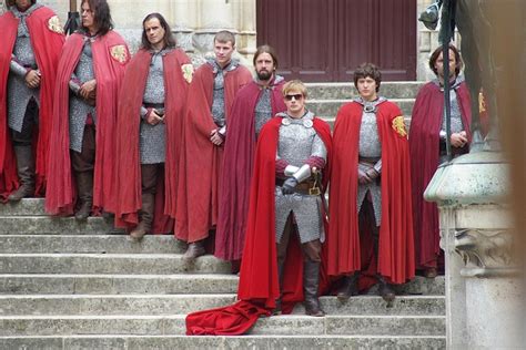 A Group Of People Dressed In Knight Costumes Standing On Steps With One