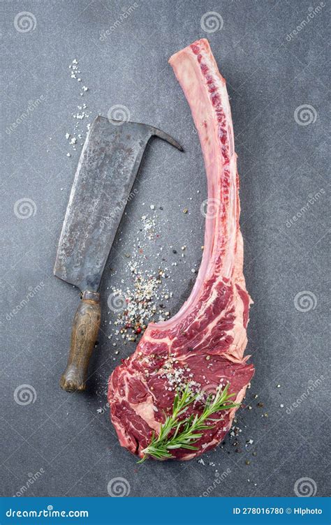 Raw Wagyu Tomahawk Beef Steak With Salt And Pepper On A Grey Design