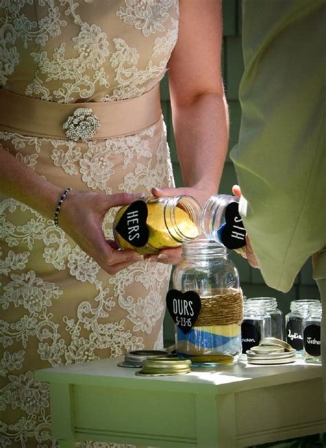 A Person Pouring Something Into A Jar On Top Of A Table