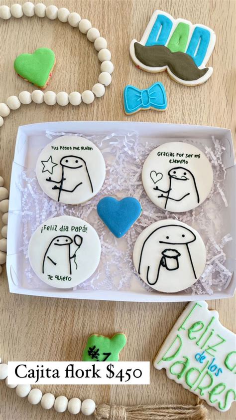 Four Decorated Cookies In A Box On A Table With Some Decorations Around