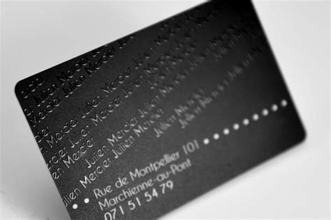 A Close Up Of A Black Business Card On A White Surface With Dots And Lines