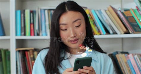 Young Asian Woman Orders Food In An Online Store Using A Smartphone