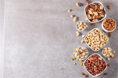 Premium Photo Healthy Mix Nuts And Dried Fruits On Wooden Background