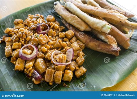 Tofu in Peanut Garlic Sauce and Dynamite Lumpia Placed on a Tray Lined with Banana Leaves. Stock ...