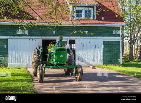 Vintage John Deere Tractor In Front Of An Old Barn Stock Photo Alamy