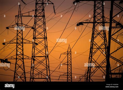 Silhouette Of The Evening Electricity Transmission Pylon At Sunset