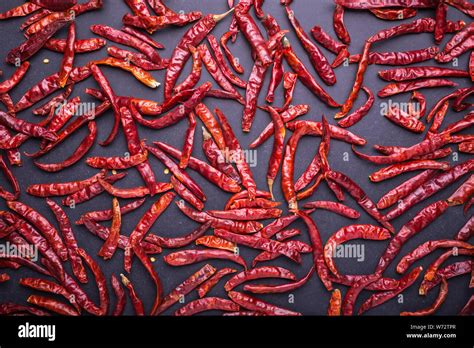 Top View Dry Red Hot Chilli On Black Stone Board Background Stock Photo