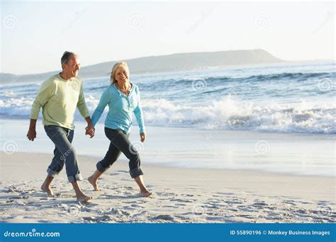 Senior Couple Walking Along Beach Stock Photo Image Of Outdoors Baby