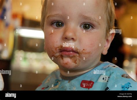 A two year old with chocolate sauce all over his face Stock Photo - Alamy