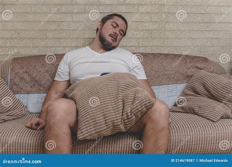 An Unkempt Unmotivated And Depressed Man Falling Asleep On The Couch