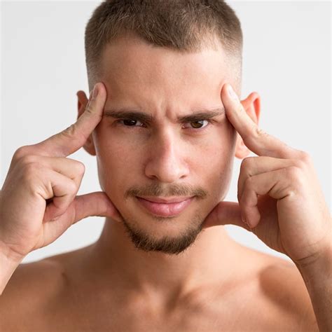 Free Photo Front View Of Shirtless Man Posing With Fingers To His Temples