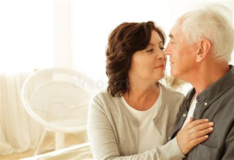 Mature Year Old Couple Hugging While Sitting On The Bed In The Bedroom Stock Image Image