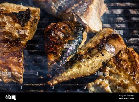 Grilled Mackerel Fish With Smoke On A Charcoal Barbecue Grill Stock