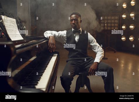 Ebony grand piano player, jazz performer Stock Photo - Alamy