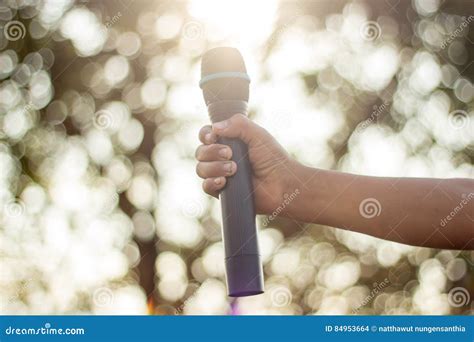 Hand Holding a Single Microphone Against Colourful Background,singing ...