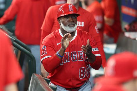 Angels coach Eric Young Sr. tossing snacks to son Eric Jr. on Mariners