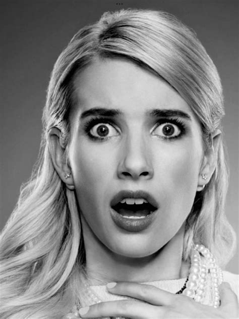 A Woman With Long Blonde Hair And Big Eyes Is Making A Surprised Face