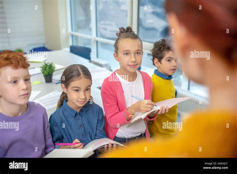 children listening   teacher   notes stock photo alamy