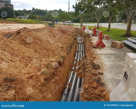 Underground Utility And Services Pipe Laid By Workers In The Trenches