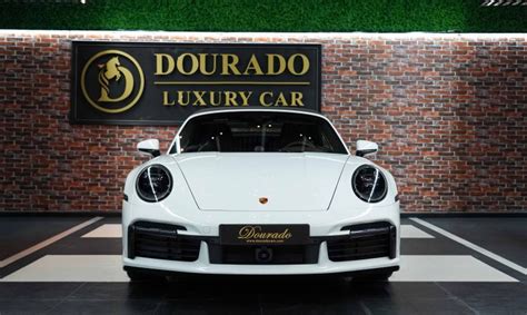 Porsche 911 Turbo S Cabriolet in white - Dourado Luxury Cars