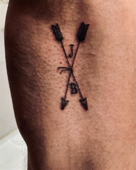 Crossed Arrows And Initials Tattoo Located On Ben