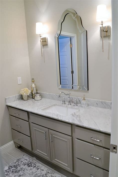 A Bathroom With Two Sinks And A Large Mirror