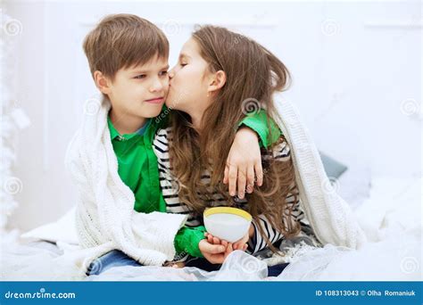 The Little Girl Kisses and Hugs Boy. the Concept of Love and Val Stock ...