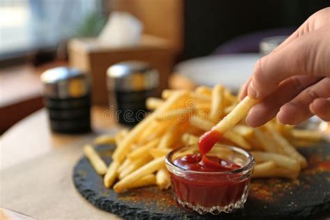 Woman Dipping French Fries into Red Sauce in Cafe, Closeup Stock Image ...