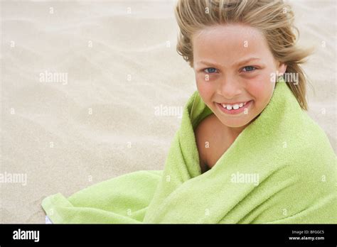 Girl Wrapped In Towel At Beach Stock Photo Alamy