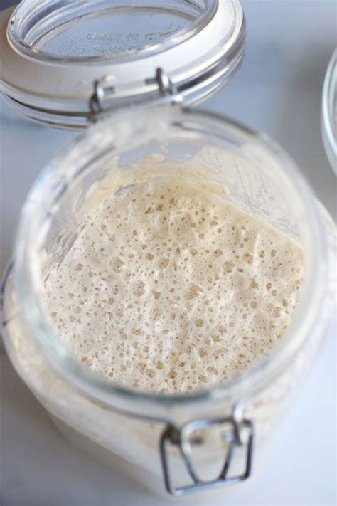 A Glass Jar Filled With Liquid Sitting On Top Of A Table