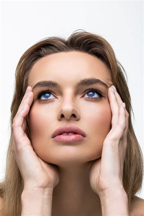 Beauty Model Girl With Perfect Make Up Looking At Camera Isolated Over