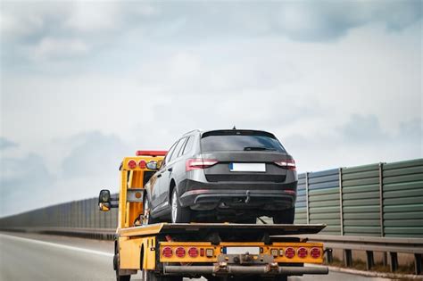 Premium Photo Emergency Roadside Assistance In Action As A Tow Truck