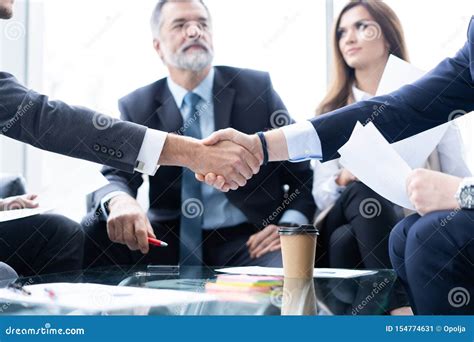 Business People Shaking Hands Finishing Up A Meeting Handshake