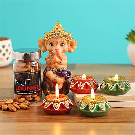 Buy Send Sitting Ganesha Idol With Almonds Diyas Online Fnp