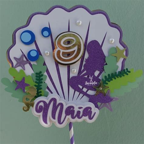 A Purple And White Cake Topper With The Number Nine On It S Side