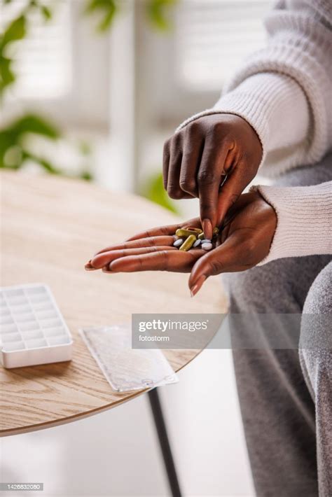 Woman Sorting Out Pills In A Pill Container High-Res Stock Photo - Getty Images