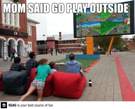 three people sitting on bean bags watching a video game in front of a ...