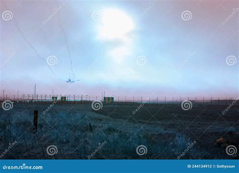 The Passenger Plane Landing At The Airport At Sunset Stock Photo