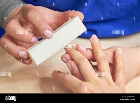 Manicurist Polishing Nails To Client Beautician Filing Nails For