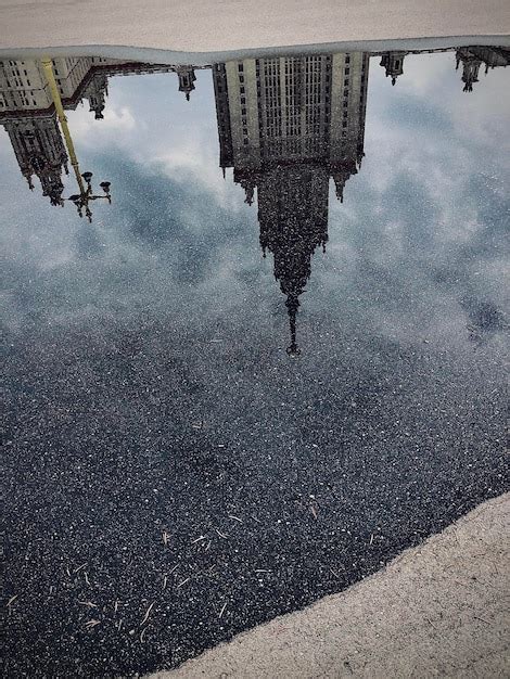 Premium Photo Reflection Of Buildings In Puddle