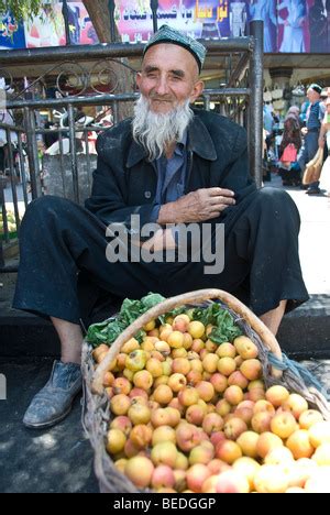 Uighur Man Selling Fruit In The Street Market Kashgar Xinjiang China