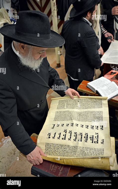 A Religious Jewish Man Reading From The Megillah During Purim Services