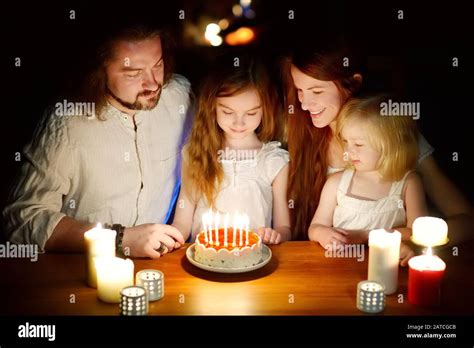 Cute Sever Year Old Girl Making A Wish Before Blowing Candles On Her