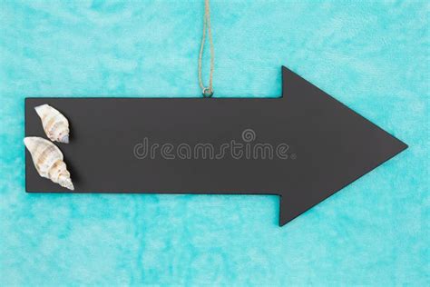 To The Beach Hanging Arrow Chalkboard Sign With Seashells Stock Photo