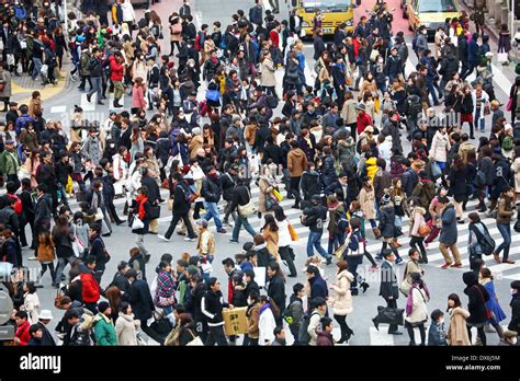 Crowds Of People At Rush Hour Crossing Pedestrian Crossings In Shibuya